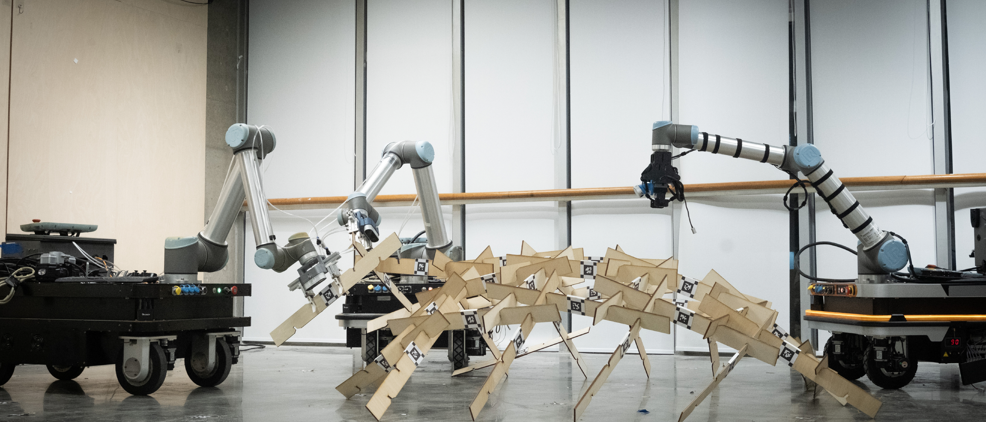 Multiple mobile robots collaborating around a construction-related setup